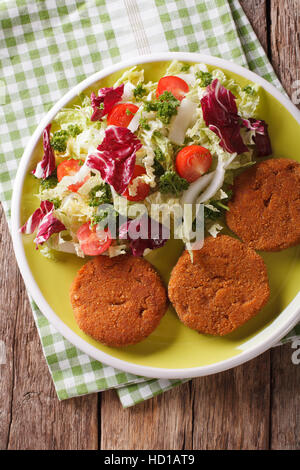 Diätetische Karotte Burger und frischem Salat mischen Nahaufnahme auf einer Platte. vertikale Ansicht von oben Stockfoto