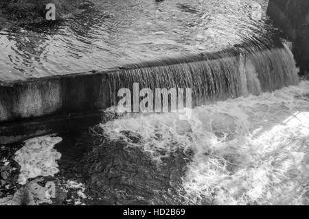 Fließendes Wasser bei Tumwater Wasserfällen schafft einen glänzende Vorhang. Schwarz / weiß Bild. Stockfoto