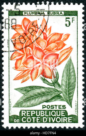 Côte d ' Ivoire - ca. 1962: Eine Briefmarke gedruckt in Côte d ' Ivoire, zeigt Blumen Plumeria Rubra, ca. 1962 Stockfoto