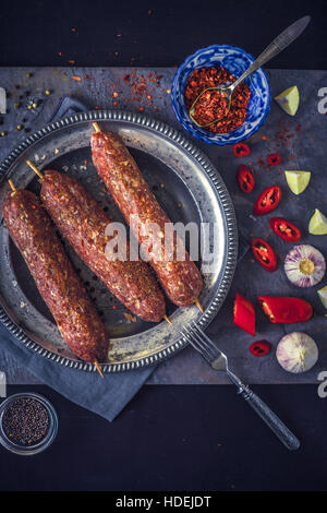 Rohe Kebab mit Würze auf den steinernen Tisch vertikal Stockfoto