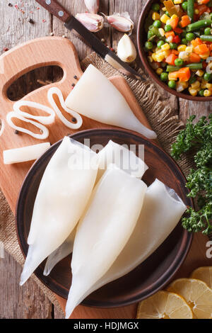 Vorbereitung der rohen Tintenfisch und Zutaten auf den Tisch. vertikale Ansicht von oben Stockfoto