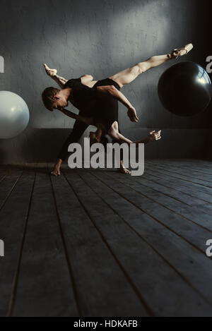 Flexible Ballett-Tänzer, die Durchführung in die enge Verzahnung Stockfoto