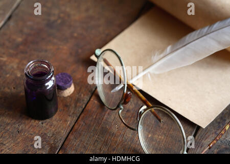 Papier und Feder Stift in der Nähe von Brille auf schönen alten hölzernen Hintergrund Stockfoto