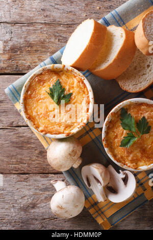 Gratin mit Hühnerfleisch und Champignons auf dem Tisch. vertikale Ansicht von oben Stockfoto