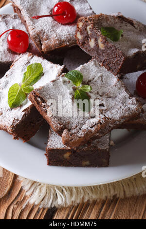 Brownie Schokoladenkuchen mit Walnüssen und Kirschen Nahaufnahme. Vertikal Stockfoto