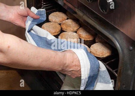 Frisch gebackenes Gebäck oder Cookies aus dem Ofen genommen werden Stockfoto