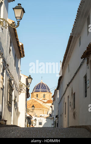Straße in der Innenstadt von Altea, eine wunderschöne Stadt an der Costa Blanca mit dem Cupule der Kirche im Hintergrund; Altea, Alicante, Spanien Stockfoto