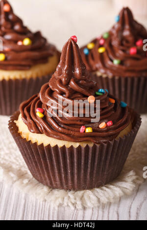 Köstlichen Urlaub Cupcakes mit Schokocreme hautnah auf dem Tisch. vertikale Stockfoto