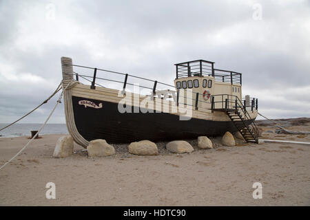 Die Beluga, ein Boot am Ufer der Hudson Bay in Churchill in Manitoba, Kanada. Das Boot steht auf Sand von der Küste. Stockfoto