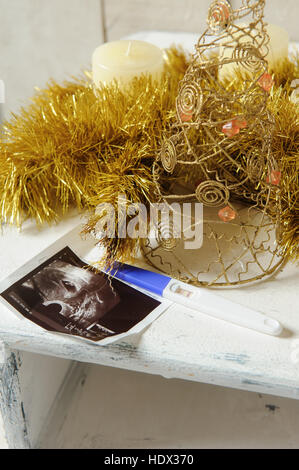 Ultraschallbild und ein Schwangerschaftstest mit Weihnachts-Dekor. Close-up. Stockfoto