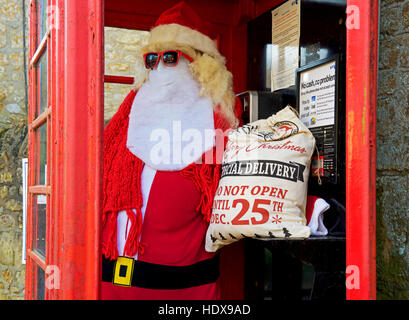 Figur des Weihnachtsmannes in roter Telefonbox, England UK Stockfoto