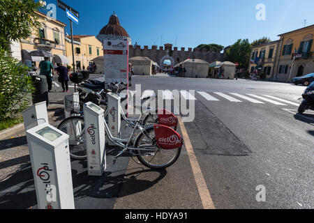 Elektrische Fahrräder zum Mieten. Die berühmten mittelalterlichen Komplex von Pisa zurück nach dem 9. Jahrhundert und einschließlich der Schiefe Turm von Pisa. Stockfoto