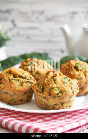 Vegane Muffins mit Spinat und Maismehl auf weißem Teller serviert. Textfreiraum Stockfoto