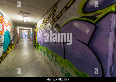 Graffiti in einer unter durchlaufen die Stadtmauern, Volterra, Toskana, Italien. Stockfoto