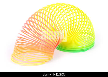 Slinky Feder Spielzeug isoliert auf weiss. Regenbogen-Feder-Spielzeug. Stockfoto