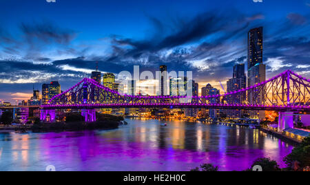 Pulsierende Nacht Zeit Panorama von Brisbane mit lila leuchtet auf Story Bridge, Australien Stockfoto
