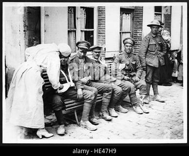 Dieses historische Foto zeigt eine französische Krankenschwester, die während des Ersten Weltkriegs britische Soldaten betreut, die als „Tommäen“ bekannt sind. Das Bild symbolisiert die Zusammenarbeit der alliierten Streitkräfte bei der medizinischen Versorgung während des Krieges. Stockfoto