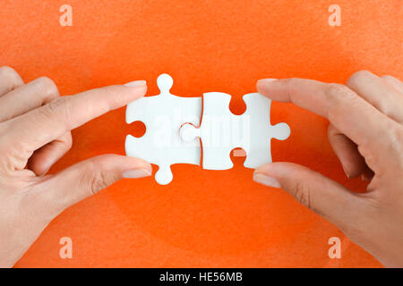 Frau Hand passend das richtige Stück puzzle vorgeschlagen Business-Networking-Konzept Stockfoto