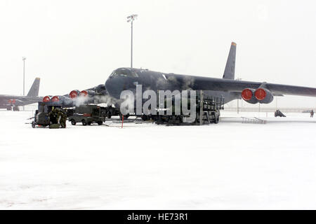 US Air Force (USAF) Personal zugewiesen, um die 23. Bomb Wing (BW) laden AGM-129 Advanced Cruise Missiles in eine B - 52H Stratofortress Flugzeug während eines Schneesturms auf dem Flug Linie an Minot Air Force Base (AFB), North Dakota (ND), während die alert-Status Teil der Übung PRAIRIE Wachsamkeit 2002. Stockfoto