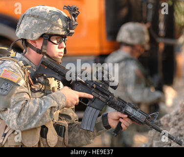 US Armee-Spezialist Nicholas Haney, 1. Zug, C Gesellschaft, 4-23-Infanterie-Regiment 172. Stryker Brigade Combat Team, führt Sicherheit während einer Patrouille in Mosul, Irak, 10. November 2005 zur Unterstützung der Operation Iraqi Freedom.    Staff Sgt James L. Harper Jr. (freigegeben) Stockfoto