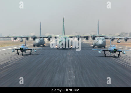 Zwei Bangladesch F-7BG Verteidiger, ein BAF C-130 Hercules und zwei US Luftwaffe C - 130H Herkules Flugzeug vorbereiten von BAF Basis Bangabandhu, Bangladesch, während der Übung zu bewältigen Süden 28. Januar 2015 auszuziehen. Die USA C - 130H erhält die 374th Airlift Wing, Yokota Air base, Japan; BAF F-7BGs 5. Geschwader zugewiesen sind und die BAF C-130 ist 101. fliegen Spezialeinheit an BAF Basis Bangabandhu zugewiesen. Süden zu bewältigen ist eine Pacific Air Forces gesponsert, bilaterale taktische Luftbrücke Übung durchgeführt in Bangladesch, mit einem Fokus auf kooperative Flugbetrieb, Tag und Nacht Low-Level-navigatio Stockfoto