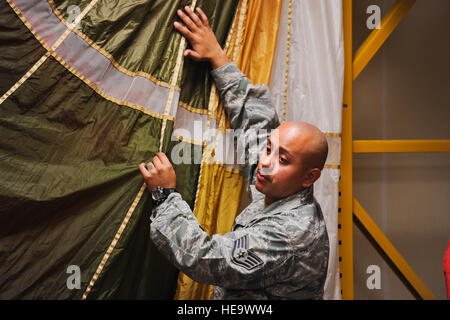 Staff Sgt Edwin Portan, 33. Operations Support Squadron f-35 Lightning II Aircrew Equipment Fortsetzung Ausbildung Fluglehrer, lehrt Studenten über das dicker und schwerer Material für das neue IRVIN-GQ-6000 während einer Wasser-überleben-Klasse auf der Eglin Air Force Base, Florida, 30. Oktober 2014 mit dem Fallschirm. Portan erstellt ein Float-Gerät von PVC-Rohren, die verhindert, dass den Fallschirm sinken auf den Boden des Pools während Studenten ihre Ausbildung absolvieren. Die achteckigen Float-Gerät erzeugt eine effektives Training-Umgebung, die Studenten mit einer stärker simulierten Wat bietet Stockfoto