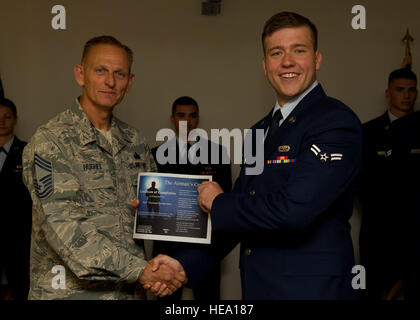 Chief Master Sgt. Robert Hughes, Materiel Pflegegruppe Chef eingetragenen Manager, präsentiert Airman 1st Class Tanner Hearren mit einem ersten Begriff Flieger Center Abschlusszeugnis in Holloman Air Force Base, N.M., 8. Juni 2015. FTAC ist ein Programm, die ersten Amtszeit Flieger mit dem Übergang von der technischen Schule in einer Betriebsumgebung hilft. Es gibt auch die Flieger ein herzliches Willkommen zu Holloman von der Mehrheit der Basis Agenturen, mit denen, die Sie, auf einer täglichen Basis zusammenarbeiten werden.   Senior Airman Leah Ferrante Stockfoto