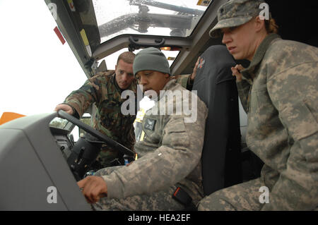 US Air Force Staff Sgt Timothy Wertz zugewiesen 910th Airlift Wing Feuerwehrmann erklärt, wie Sie betreiben ein Stryker-Feuerwehrauto, US Army Staff Sgt Leon Daniels und Spc. Victoria Wald sowohl 2-238th AVN GSAB während Global Medic/Krieger, Schoonover Flugplatz, Fort Hunter Liggett, zugewiesen sind Kalifornien, 17. Mai 2011. Globale Medic/Krieger ist eine gemeinsame Reserve Feld Trainingsübung für Theater aeromedical Evakuierung System und Boden medizinische Komponenten entwickelt, um alle Aspekte der medizinischen Kampfunterstützung zu replizieren.  Francisco V. Govea II) Stockfoto