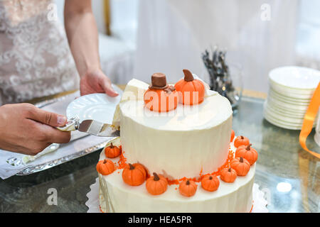 Hochzeitstorte mit roten Rosen. Orange Stockfoto