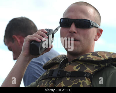 Ein Fallschirmjäger zugewiesen, die 4. Infantry Brigade Combat Team (Airborne), 25. Infanterie-Division, U.S. Army Alaska, hört Funkverkehr in einen Wassergraben in Big Lake, Alaska, Mittwoch, 6. August 2014, mit t-11 Fallschirme. Diese Fortbildungsveranstaltung bereitet die Brigade Trooper für potenzielle Wasser Landungen und hebt das Gerät Fähigkeit Luftlandeoperationen unter schwierigen Bedingungen und Standorten überall in der Welt durchführen. Justin Connaher) Stockfoto