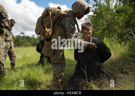 Eine Marine führt der richtigen Weg, um Häftlinge für Bedrohungen im Rahmen einer taktischen Wiederherstellung Flugzeug prüfen und Schulung des Personals trainieren Sie im Camp Lejeune, North Carolina, 21. September 2016. Marines mit Charlie Kompanie, 1. Bataillon, 2. Marine Regiment, 2. Marine-Division führte das Training zur Vorbereitung ihrer Falle Kraft Rolle während der kommenden Special-Purpose Marine Air Ground Task Force, Krise Antwort-Afrika Bereitstellung.  Lance CPL Victoria Ross) Stockfoto