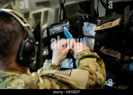 Taktische Intensivpflege expeditionary Team – erweitert (TCCET-E) Team-Mitglied, Captain Richard Rogers, Krankenschwester Anästhesisten, 86. Medical Group, Ramstein Air Base, Deutschland, bereitet Naht Thread während während des Fluges an Bord einer c-17 Globemaster III am Joint Readiness Training Center (JRTC), Fort Polk, Louisiana, 17. Januar 2014. Service-Mitglieder am JRTC 14-03 sind in Bekämpfung Patientenversorgung und aeromedical Evakuierung in einer simulierten Kampf Umgebung ausgebildet.  Master Sergeant John R. Nimmo, Sr. /) Stockfoto