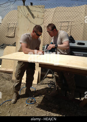 Arbeiten Sie Staff Sergeant Logan Kendrick, 455. Expeditionary Medical Support Squadron Einrichtungsleiter (links) und techn. Sgt Sheldon Milligan, 455. Expeditionary Air Wing Kaplan Assistent, auf den Aufbau der Schränke auf Bagram Air Field, Afghanistan, 6. April 2013. Die Schränke wurden von Grund auf für die neue "Heilige Joes" Pausenraum im Craig Joint Theater Krankenhaus gebaut. (Foto mit freundlicher Genehmigung von techn. Sgt Sheldon Milligan US Air Force) Stockfoto