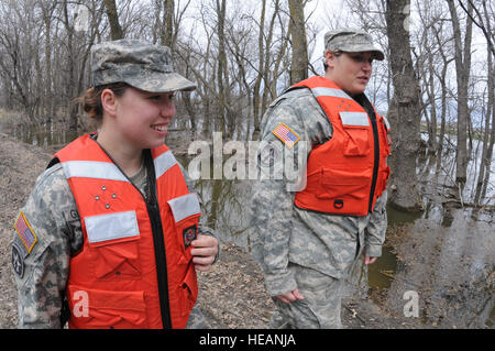 (Von links nach rechts) SPC. Sandra Gillespie und Sgt. Shannon Welsh, beide 191. Military Police Company, Fuß entlang einer ländlichen Flut Schutz Damm in der Nähe von Kindred, N.D., 26.April. Die Soldaten beobachten die Flut Dämme, um sicherzustellen, gibt es keine Erosion, die Bereiche Entwicklung, die in großen Flut Barriere Verstöße verwandeln können die Stadt Kindred gefährden könnten. Etwa 150 North Dakota National Guard Mitglieder weiterhin für schnelle Reaktion erzwingen Missionen und Deich Patrouillen und laufen einem tactical Operations Center zur Unterstützung der Bekämpfung der Flut Bemühungen in North Dakota. Stockfoto