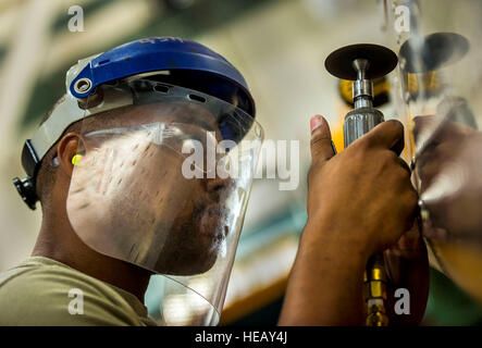 Ein Airman schleift ein Stahlrohr an der Joint Base Charleston, um Blecharbeiten an einem C-17 Globemaster III Flügel zu simulieren. Die Aufgabe wird von einem Fachmann für Flugzeugmetalle durchgeführt, der der 437th Maintenance Squadron als Teil der Flugzeugwartung zugeteilt ist. Stockfoto
