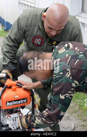 Philippine Air Force Staff Sgt Henry B. San Juan inspiziert Flugzeug Absturz Bergegerät mit U.S. Marine Corps Lance Cpl. David Landa während einer Fortbildungsveranstaltung 6. Mai 2014 auf Clark Air Base, Philippinen. Im 30. Jahr ist Balikatan einen jährlichen Übung, die die Interoperabilität zwischen der Streitkräfte der Philippinen und US-Militär in ihrem Engagement für regionale Sicherheit und Stabilität, humanitäre Hilfe und Katastrophenhilfe stärkt. Das Training ist Bestandteil einer Reihe von gemeinsamen Veranstaltungen zur Verbesserung der Effizienz zwischen Flugzeugen Rettung und Brandbekämpfung Marin Stockfoto