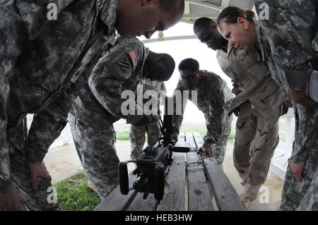 GUANTANAMO BAY, Kuba – Joint Task Force Guantanamo Mitglieder lernen, wie man richtig eine.50 Kaliber Maschinengewehr montieren während der Einarbeitung Ausbildung, 6. Oktober 2010. JTF Guantanamo bietet sichere, humane, legale, transparente Pflege und Obhut der Gefangenen, einschließlich der Militärkommission und die verurteilten freigegeben von einem Gericht angeordnete. Die JTF führt Intelligenzansammlung, Analyse und Verbreitung für den Schutz von Insassen und Personal arbeitet in JTF Guantanamo Einrichtungen und zur Unterstützung des Krieges gegen den Terror. JTF Guantanamo bietet Unterstützung für das Office of Military Commissions Stockfoto