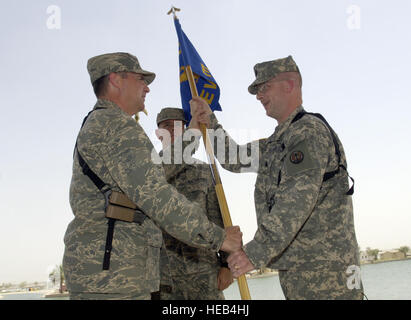 Bagdad, Irak--US Air Force Master Sgt. Todd Winters (Mitte) schaut zu, wie Oberst Eric Schnitzer (links), Kommandeur der 3. Expeditionary Air Support Operations Group, während eine Übernahme der Befehl Zeremonie am 3. Juni 2007 3. Expeditionary Wetter Squadron Guidon, Oberstleutnant John Hennessey Hände. Oberstleutnant Hennessey, der regiert von Fairfax, VA., übernimmt das Kommando des Geschwaders, die offiziell am 31. Mai 2007 stand auf. Mit Sitz am Camp Sieg in Bagdad, Irak, bietet das Geschwader Schlachtfeld Wetterfrösche an 13 Standorten im gesamten Irak. Die 3. Staffel Wetter hat seinen Sitz in Ft. Stockfoto