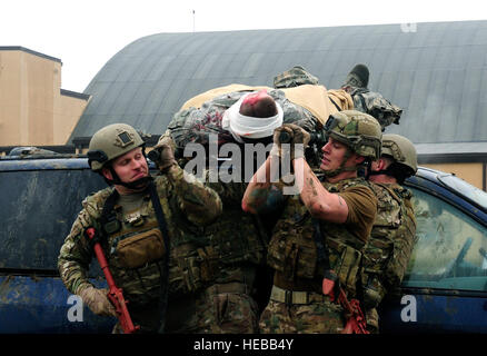 Drei Teams der vier Flieger transportieren Simulationspatienten über eine Fahrzeuge und dabei einen Blick heraus für feindliches Feuer während einer Übung Tactical Combat Casualty Care auf der Scott Air Force Base, Ill., 4. Dezember 2014. Das Ziel des Teams war, dass zwei ihrer Patienten an eine Stelle bekommen wo sie zu einer höheren Ränge der Pflege transportiert werden würde. Die Teams alle Flieger mit dem 375-jährigen Air Mobility Wing und 932nd Airlift Wing Explosive Ordnance Flüge zusammengesetzt hatte vier Rollen, Sanitäter, Arzthelferin, Teamleiter und ein Sicherheits-Mitglied. Stockfoto