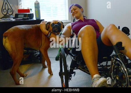 Ehemaliger US Air Force major Jen Kyseth, Züge auf ihr Liegerad, während ihr Hund Mack an ihrer Seite, Sumter, SC, 15. September 2014 wartet. Jedes Mal, wenn Kyseth auf ihrem Fahrrad trainiert, ist Mack es mit ihr, als ob er versucht, Unterstützung zu zeigen, die ihre Motivation steigert. (Foto: U.S. Air Force Airman 1st Class Diana M. Cossaboom/freigegeben) Stockfoto