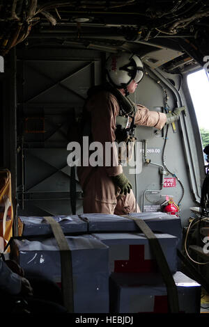 Zugewiesene VMM-265, 1st Marine Aircraft Wing, 3rd Marine Expeditionary Force Marine bereitet sich auf eine Mission an Bord ein MV-22 Osprey, beladen mit Hilfsgütern während eines gemeinsamen humanitäre Hilfe/Disaster Relief Trainings von Yokota Air Base, Japan, 31. August 2014 gestartet. Piloten und Marines führte die Übung zur Steigerung der gemeinsamen Interoperabilität und Krise Reaktionsmöglichkeiten im Falle einer Naturkatastrophe betroffen Menschen ausüben. (US Air Force Foto von 1st Lt. Jake Bailey/freigegeben) Stockfoto