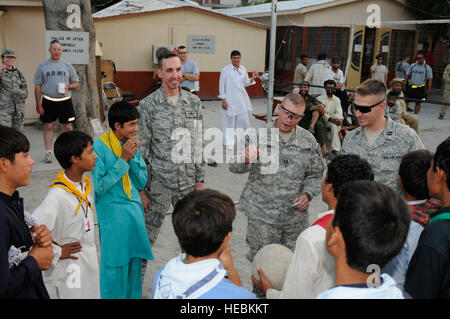 Provinz NANGARHAR, Afghanistan – US Army Lt. Col. Brent Grometer von Los Altos, Kalifornien, Nangarhar Provincial Reconstruction Team Kommandant; US Army Captain Glenn Battschinger Maye zu landen, N.J., PRT zivile Angelegenheiten; und US Air Force Captain Michael Robb von Gloversville, N.J., PRT Intelligenz, sprechen mit der PRT Nangarhar Truppe 1 Truppenführer nach einem Volleyball Spiel bei nach vorne Operating Base Finley-Schilde 6 Juli. Das FHM-Ziel ist die Pfadfinder-Truppe, ein Programm für die Kinder Afghanistans seit 1973 verboten neu starten. (Foto von US Army Captain Maria Danner-Jones, PRT Nangarhar Öffentlichkeit Stockfoto