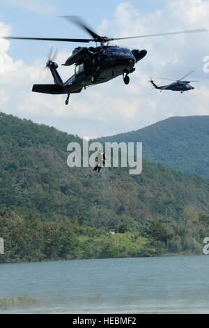 Eine südkoreanische Luftwaffe Rettungsteam hebt Oberstleutnant Jeremy Quatacker, 8. Kämpfer-Flügel-Chef der Sicherheit, Kunsan Air Base, Südkorea, aus dem Okjeongho Reservoir, Gunsan, Südkorea, 19. September 2012, während der Kampf gegen Wasser Überlebenstraining. Diese Ausbildung lehrt Piloten signal um Hilfe, den Feind zu entziehen und erhalten von Pararescuemen gerettet. (U.S. Air Force Photo/Senior Airman Marcus Morris) Stockfoto