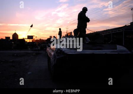 Irakische Soldaten zugewiesen, 2. Bataillon, 2. Brigade, 9. irakische Armee-Abteilung (mechanisiert) sorgen für Sicherheit auf den Straßen von Abu Atham, Irak, 30. November 2007, während ein Kordon und klopfen Mission zur Unterstützung der Operation Iraqi Freedom. (US Air Force Foto von techn. Sgt. William Greer/freigegeben) Stockfoto