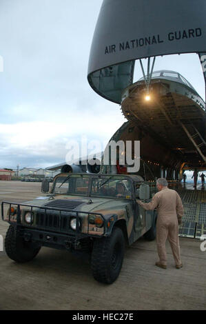 Master Sergeant Bob Mechan, eine c-5 Loadmaster mit der New York Air National Guard, spricht mit Armee Sgt. 1. Klasse Jason Rittichier, 1. Bataillon, 228th Aviation Regiment, da er einen Humvee in das Flugzeug unterstützt. Ein Team von 19 Piloten und Soldaten und zwei Hubschrauber vom Joint Task Force-Bravo ging hier 5 November Überschrift für die Dominikanische Republik, mit Bemühungen um einen Aufschwung im Zuge der Tropensturm Noel zu unterstützen. Stockfoto