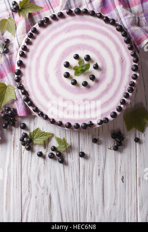 Lecker Käsekuchen gestreiften schwarzen Johannisbeeren auf dem Tisch. vertikale Ansicht von oben Stockfoto