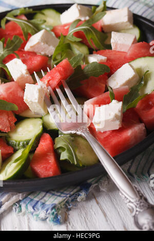 Salat aus Wassermelone und Feta, Rucola, Gurke Closeup auf einem Tisch. vertikale Stockfoto