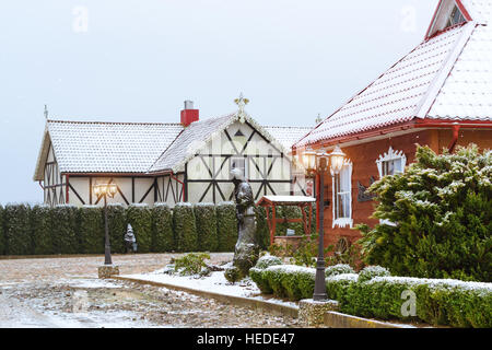 Litauische Landschaft, schneereiche Winter. Baltischen Volksarchitektur mit Holzhäusern, angelegten Park und Restaurant traditionelle litauische Küche Stockfoto