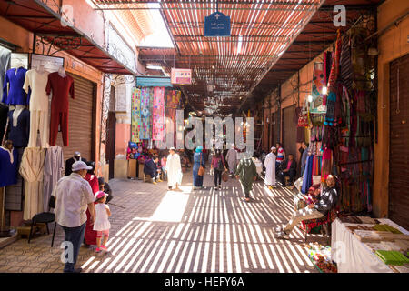 Touristen und Einheimische ein Spaziergang durch die Souks in der alten Medina von Marrakesch, Marokko Stockfoto