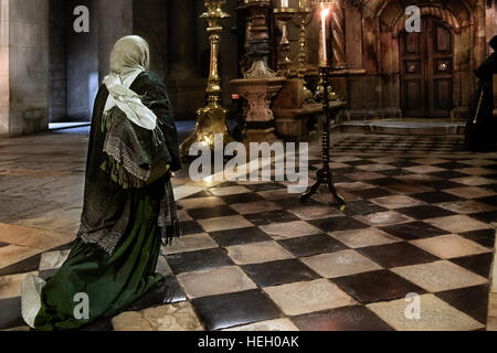 Jerusalem, Israel - 12. Dezember 2010: Ein Pilger betet auf den Knien vor AEDI-Kapelle in Heilig-Grab-Kirche Stockfoto